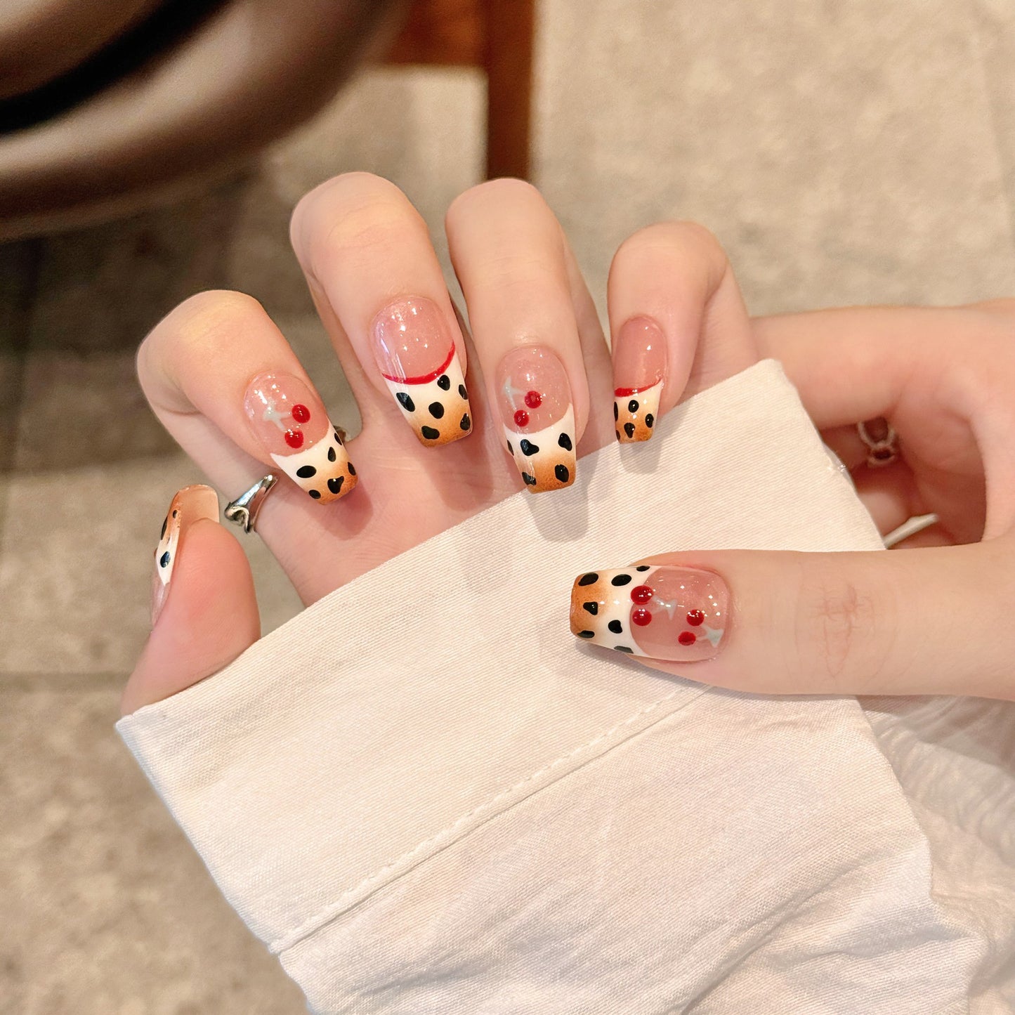 Hand-painted gradient French manicure with leopard print and three-dimensional bowknot