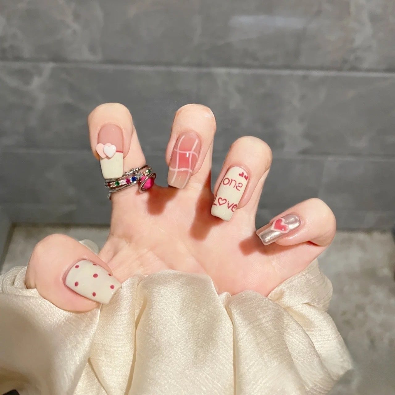 Handmade press-on nails with blush and doodle polka dots