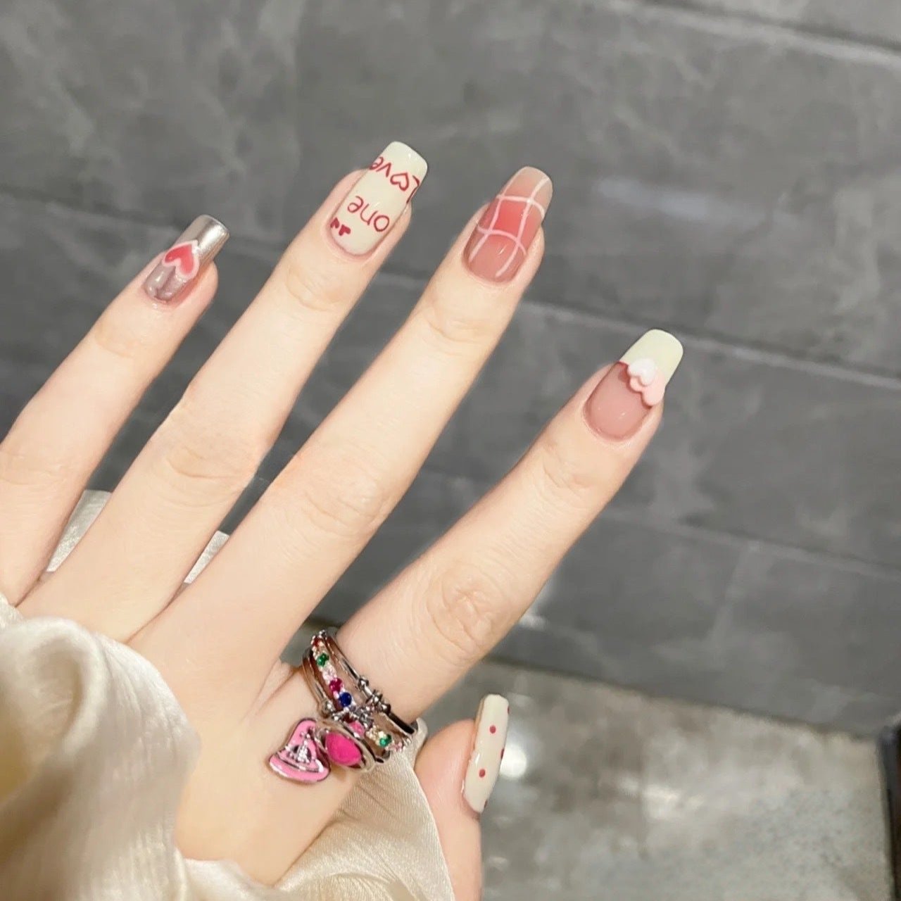 Handmade press-on nails with blush and doodle polka dots